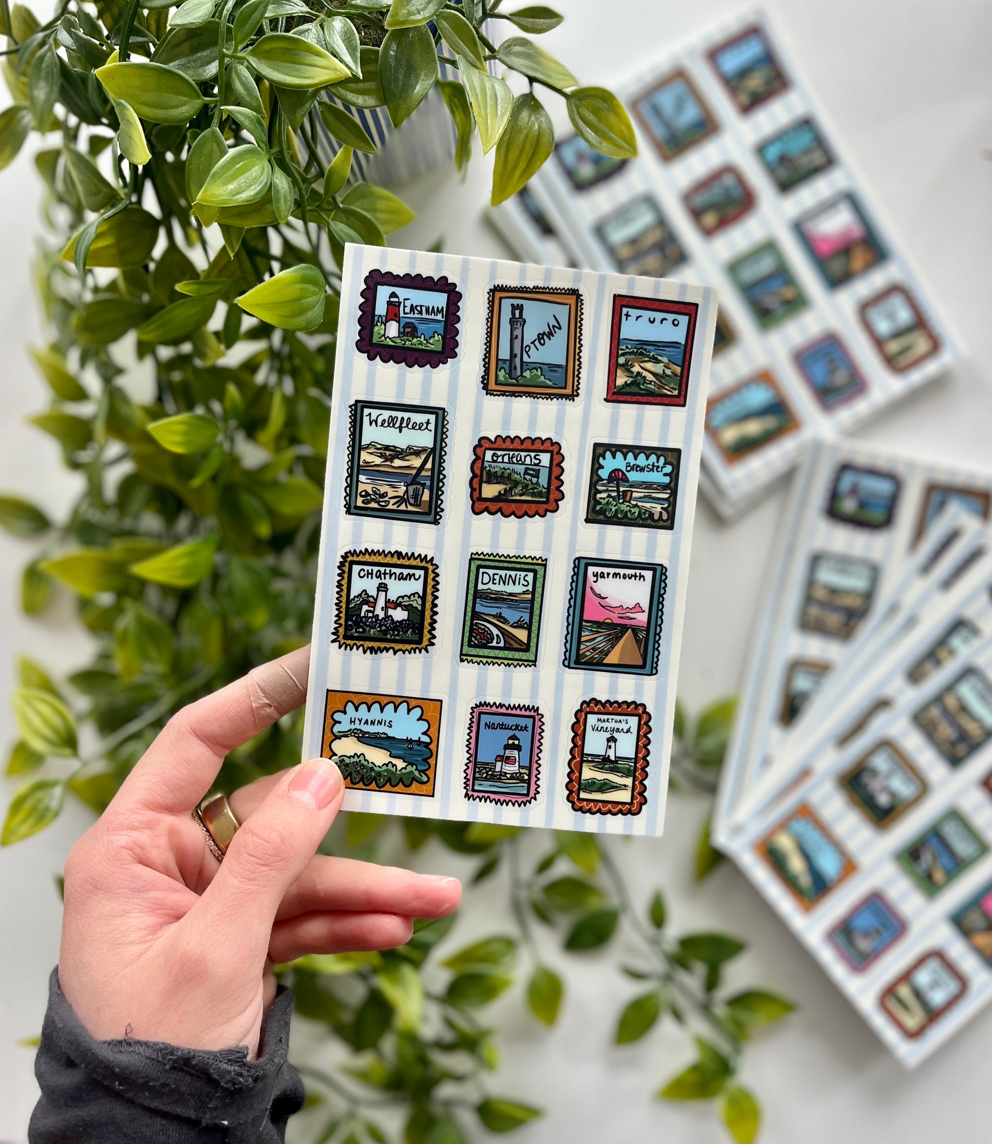 Cape Cod town-themed sticker sheet with hand-drawn stamp-style illustrations of Nauset Light, Wellfleet oysters, and Nantucket